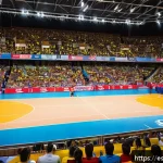 배구 경기장에서 팬과의 교류 - A vibrant indoor volleyball arena in Spain during a lively match, showcasing close interaction betwe...